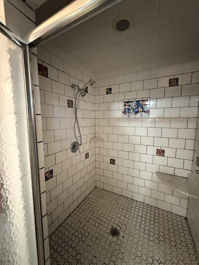 bathroom with tiled shower