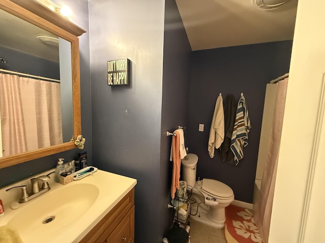 bathroom featuring tile patterned flooring, vanity, and toilet