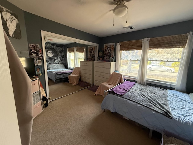 bedroom featuring ceiling fan, carpet floors, and a closet