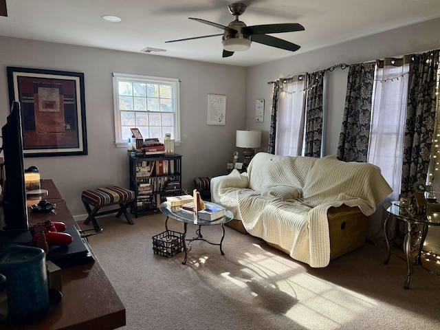 living room featuring carpet flooring and ceiling fan