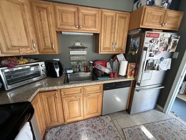 kitchen featuring sink, light tile patterned floors, and stainless steel appliances