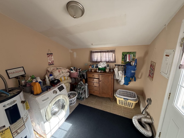 laundry room with water heater and washer / dryer