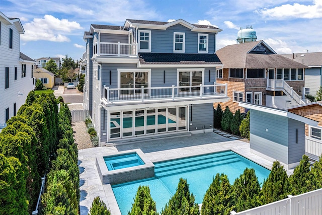 151 37th St, Avalon, NJ 08202 - back of house with a balcony, a patio, a pool with connected hot tub, and a fenced backyard