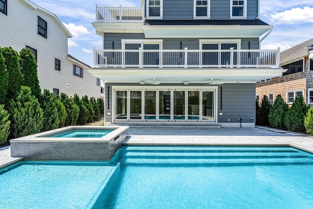 151 37th St, Avalon, NJ 08202 - rear view of house with a balcony, an in-ground hot tub, a patio, an outdoor pool, and a ceiling fan