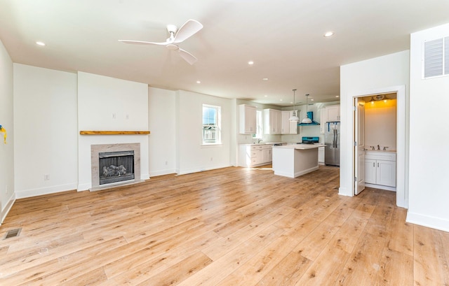 116 W Columbine Rd W, Unit West, Wildwood Crest, NJ 08260 - unfurnished living room featuring light wood-style floors, ceiling fan, a premium fireplace, and recessed lighting