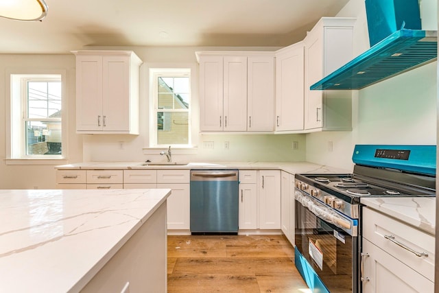 116 W Columbine Rd W, Unit West, Wildwood Crest, NJ 08260 - kitchen featuring appliances with stainless steel finishes, custom range hood, white cabinets, and light wood-style flooring