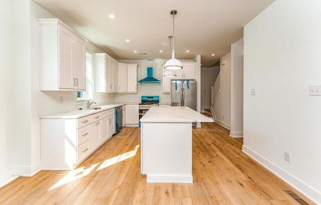 116 W Columbine Rd W, Unit West, Wildwood Crest, NJ 08260 - kitchen featuring appliances with stainless steel finishes, wall chimney range hood, a center island, recessed lighting, and light wood-style floors
