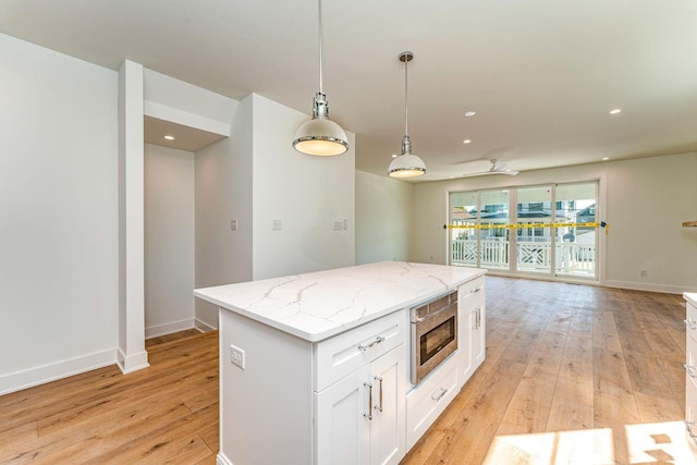 116 W Columbine Rd W, Unit West, Wildwood Crest, NJ 08260 - kitchen with open floor plan, light wood-type flooring, white cabinets, a kitchen island, and pendant lighting