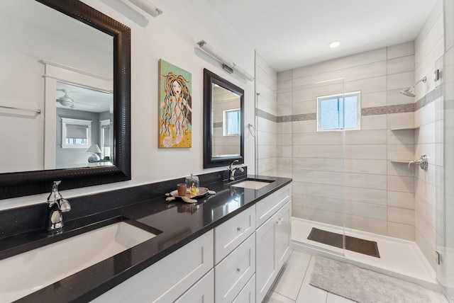full bath with a stall shower, double vanity, tile patterned floors, and recessed lighting