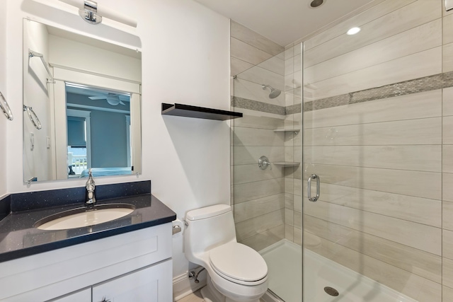 full bath featuring a shower stall, toilet, vanity, and recessed lighting