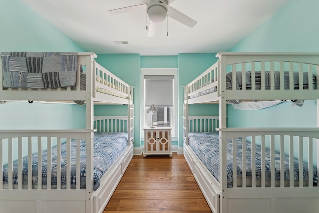 bedroom featuring wood finished floors and baseboards