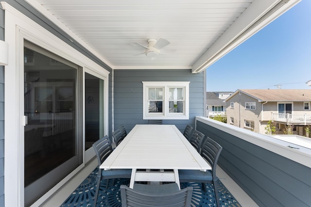 balcony featuring a ceiling fan, outdoor dining space, and a residential view