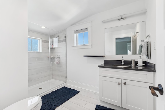 full bathroom with a shower stall, vaulted ceiling, toilet, vanity, and baseboards