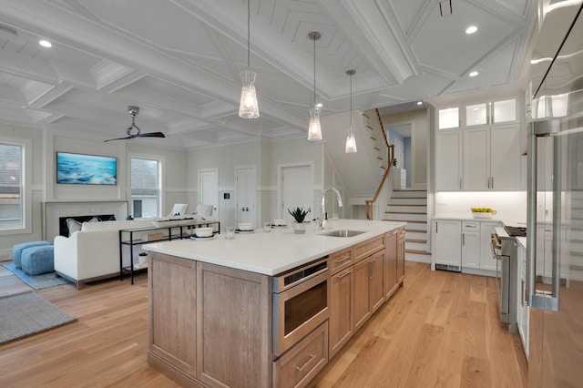 2045 W Ave, Ocean City, NJ 08226 - kitchen featuring a sink, coffered ceiling, stainless steel appliances, light wood finished floors, and light countertops