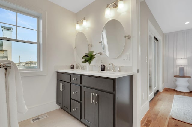 2045 W Ave, Ocean City, NJ 08226 - bathroom with double vanity, wood finished floors, and baseboards