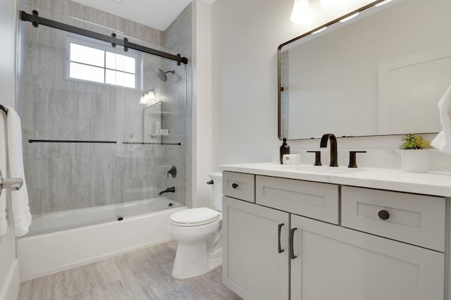2045 W Ave, Ocean City, NJ 08226 - full bathroom featuring vanity, toilet, shower / bath combination with glass door, and wood finished floors