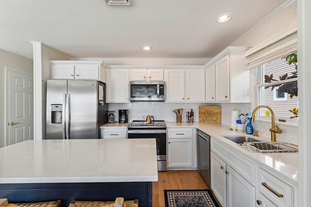 460 20th St Fl 2Nd, Avalon, NJ 08202 - kitchen with appliances with stainless steel finishes, light wood finished floors, white cabinetry, tasteful backsplash, and recessed lighting