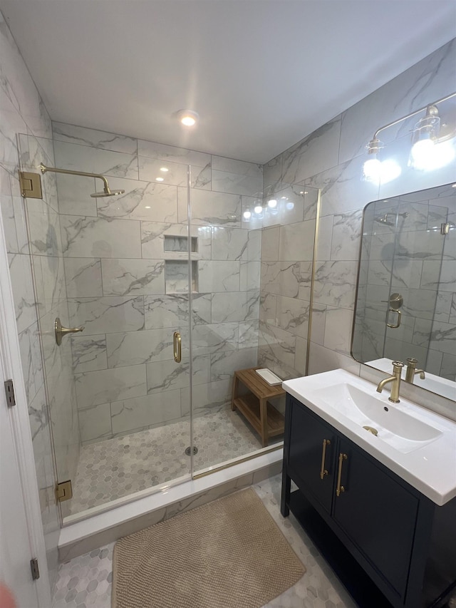 bathroom with tile patterned flooring, vanity, and an enclosed shower