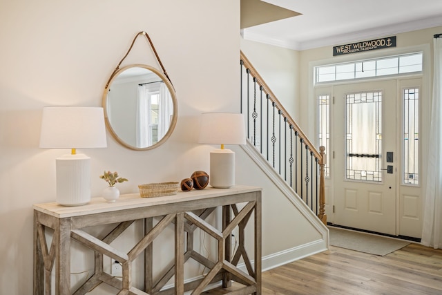 entrance foyer with crown molding and light wood-type flooring