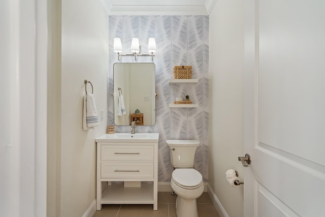 bathroom featuring toilet, vanity, tile patterned floors, and ornamental molding