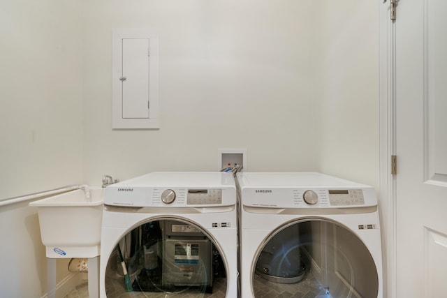 clothes washing area featuring washer and dryer and electric panel