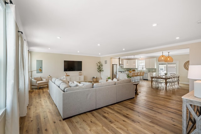 living room featuring light hardwood / wood-style floors and ornamental molding