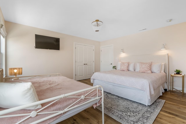 bedroom featuring hardwood / wood-style flooring and a closet