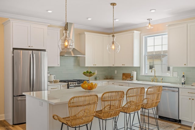 kitchen featuring sink, a center island, hanging light fixtures, and appliances with stainless steel finishes