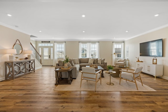 living room with light hardwood / wood-style floors and crown molding