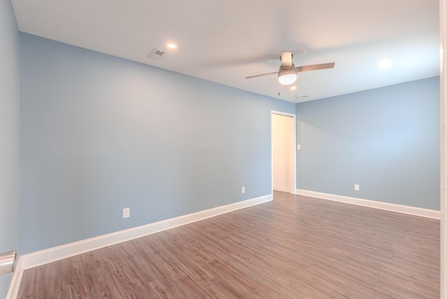 spare room with light wood-type flooring and ceiling fan