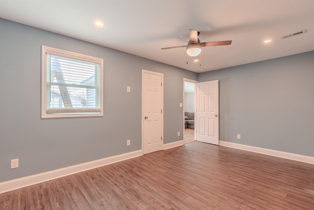 unfurnished room with hardwood / wood-style floors and ceiling fan