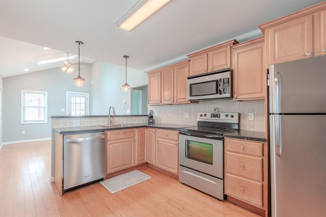 kitchen with sink, light hardwood / wood-style flooring, hanging light fixtures, stainless steel appliances, and light brown cabinetry