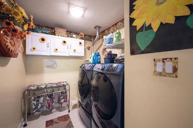 laundry room featuring cabinets, a textured ceiling, and independent washer and dryer