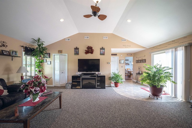 carpeted living room featuring ceiling fan and lofted ceiling