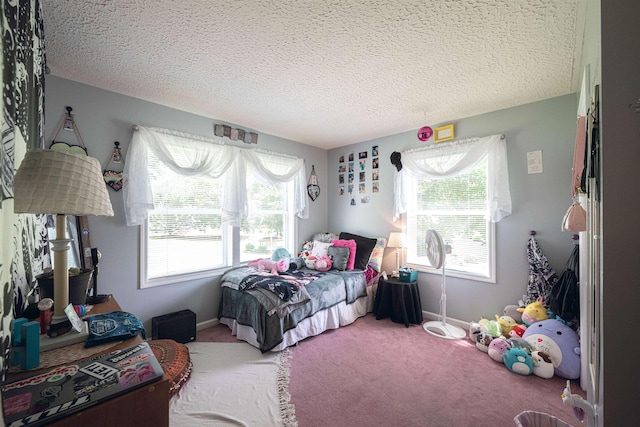 bedroom with carpet floors and a textured ceiling