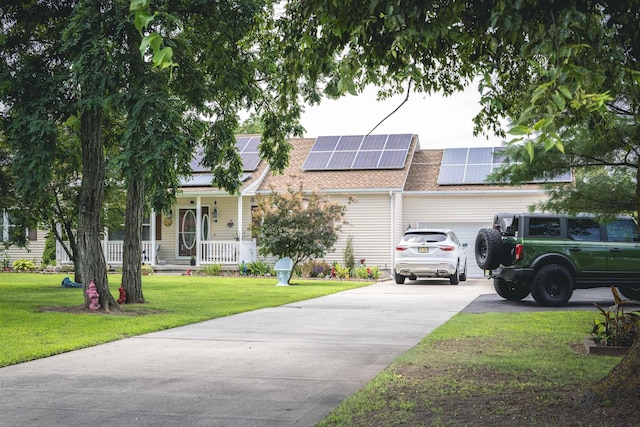 view of front of property with solar panels, a garage, covered porch, and a front yard