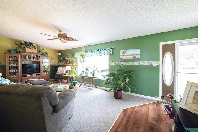 living room featuring a wealth of natural light, ceiling fan, a textured ceiling, and hardwood / wood-style flooring