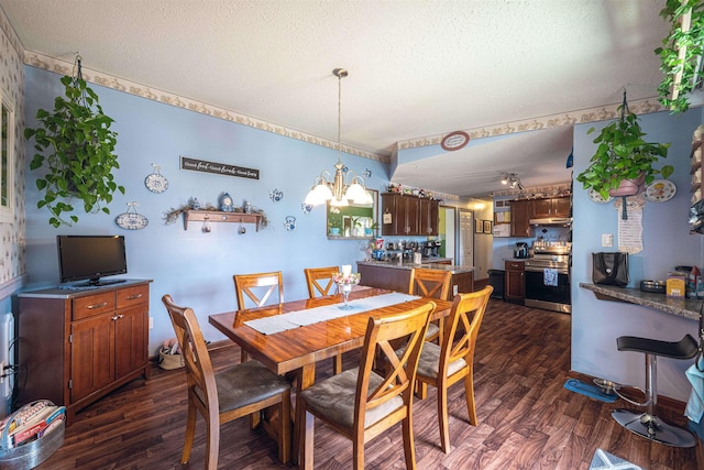 dining space featuring dark hardwood / wood-style flooring, a textured ceiling, and an inviting chandelier