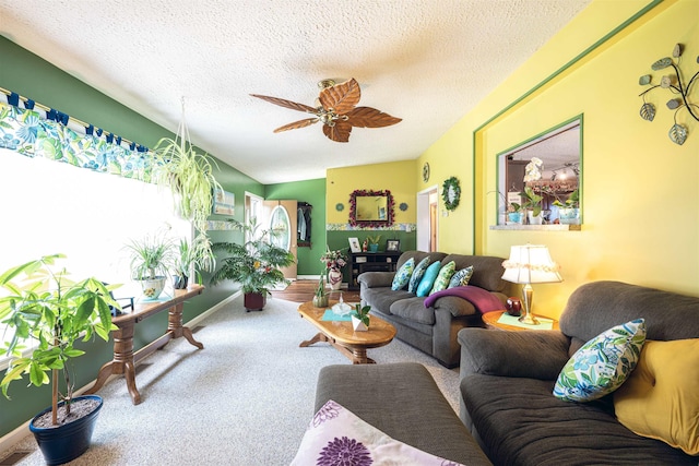 carpeted living room with ceiling fan and a textured ceiling