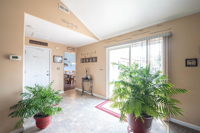 doorway to outside with vaulted ceiling