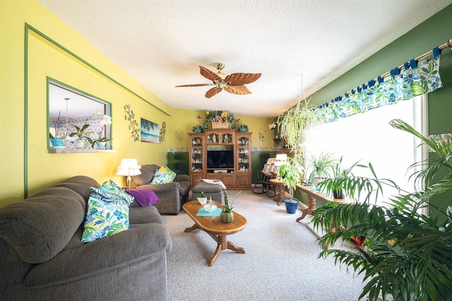 carpeted living room with a textured ceiling and ceiling fan