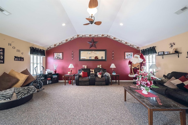 carpeted living room with ceiling fan, a healthy amount of sunlight, and vaulted ceiling