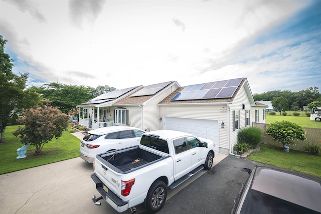 view of front of house with a garage, a front yard, and solar panels