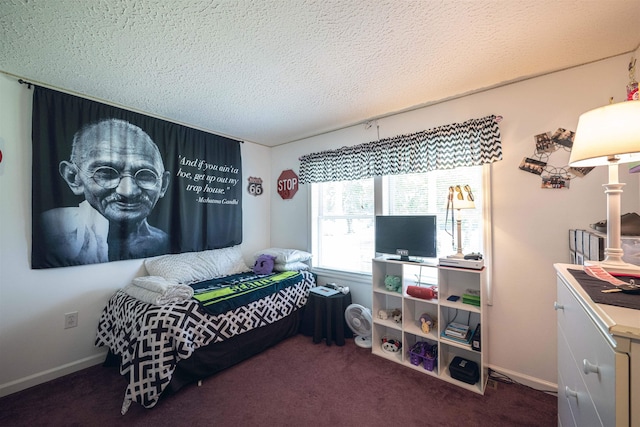 bedroom featuring a textured ceiling and dark carpet