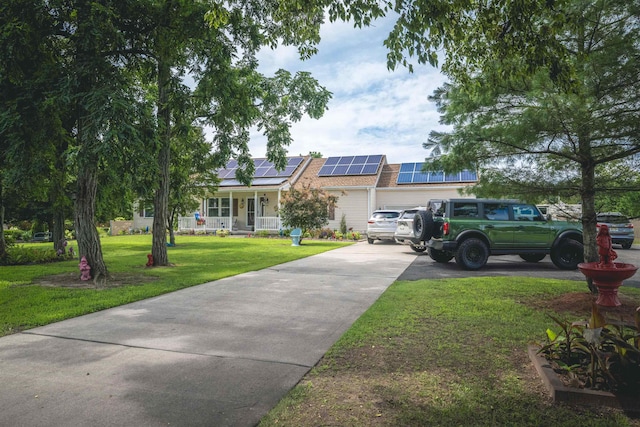 view of front of house featuring a front lawn, covered porch, and solar panels