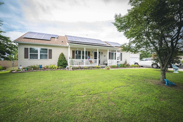 view of front of property with a garage, covered porch, a front yard, and solar panels