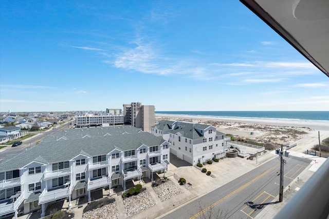 aerial view with a water view and a view of the beach