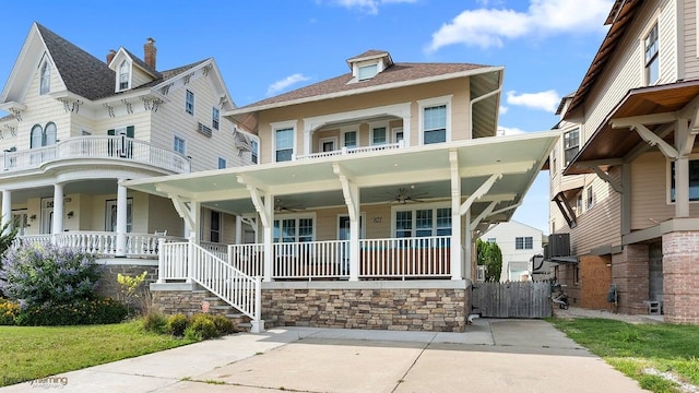 view of front of home featuring a porch, a balcony, cooling unit, and ceiling fan