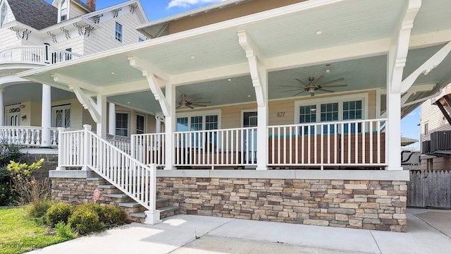 doorway to property with a porch, central AC, and ceiling fan