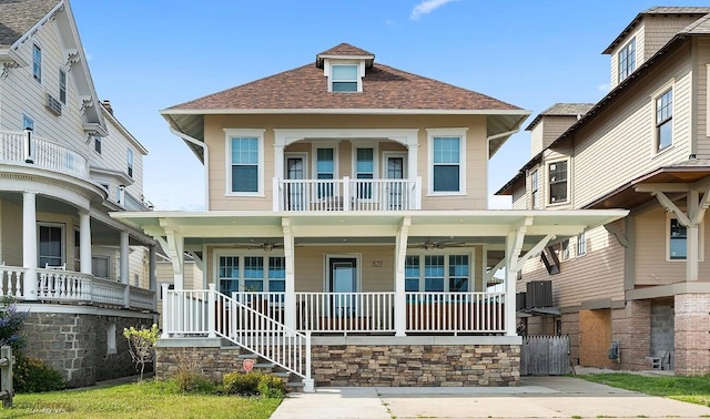 view of front facade featuring ceiling fan, covered porch, and a balcony